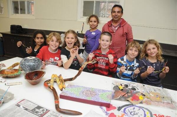 Creating Aboriginal art pieces during school holidays are (back) Zachiah Riley, Eddy Harris, (front) Adarnna Riley, Ian and Caitlyn Hillsley, Xavier Ryan, Rory and Araminta Hurford.	Photo: AMY MCINTYRE