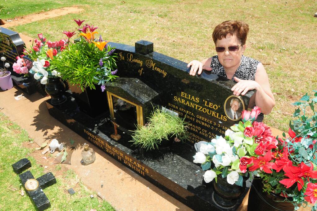 Anna Sarantzouklis holds back tears as she looks in horror at her husband’s desecrated grave. 	Photo: KATHRYN O'SULLIVAN
