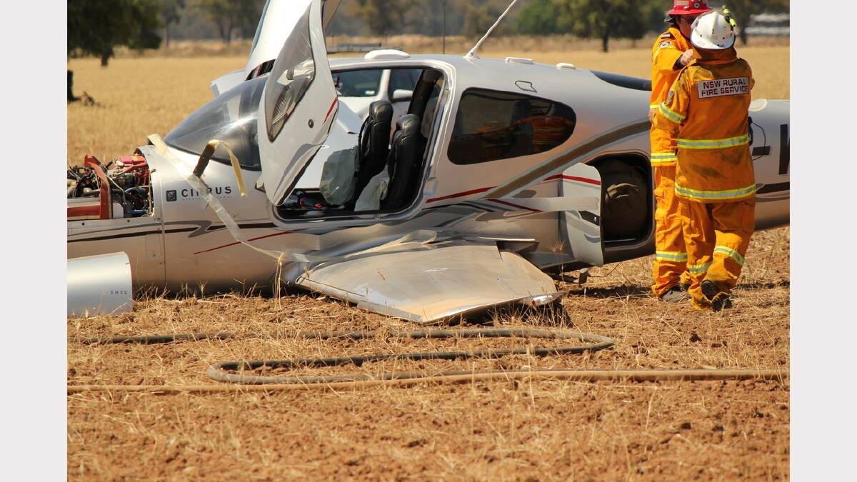 Rural Fires Service volunteers tend to the crashed plane on Wednesday afternoon. Photo: Elizabeth Smith, Gilgandra Weekly
