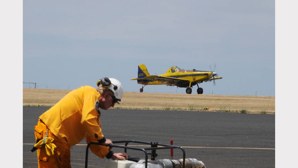 Support crews at the Coonabarabran Aerodrome were flat out filling planes with water and fire retardent. 	Photos: AMY McINTYRE