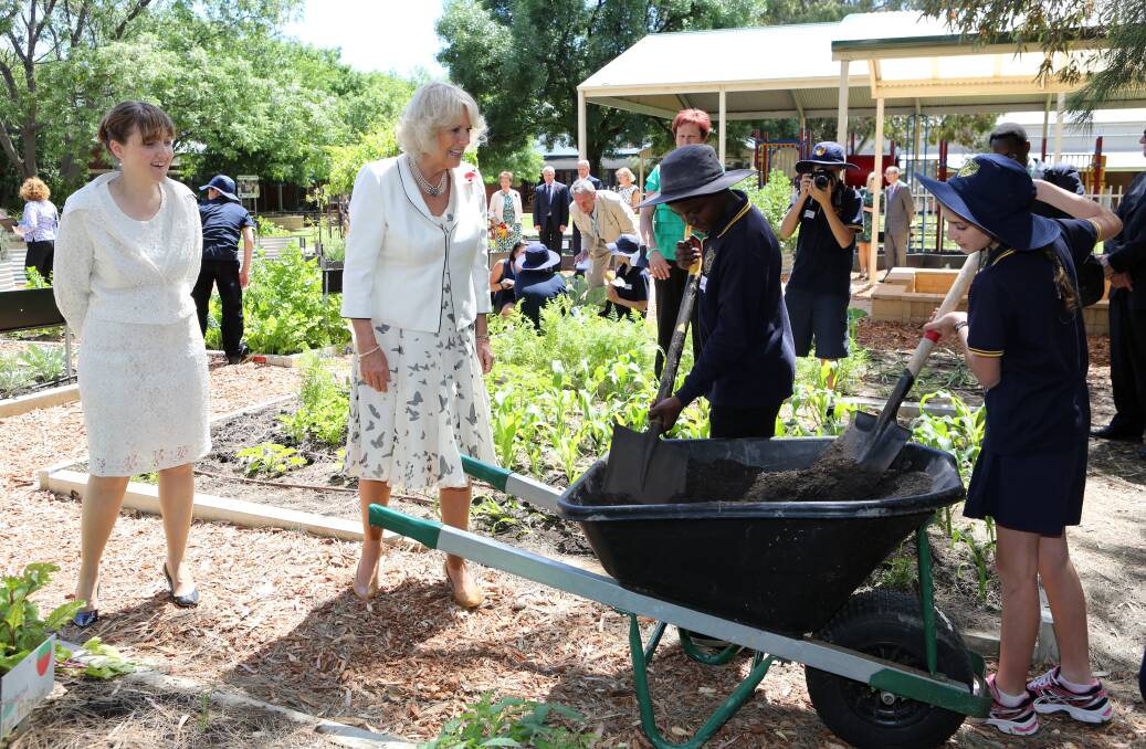 The Duchess of Cornwall, accompanied by the South Australia Minister for Education and Child Development, Grace Portolesi, as they talk to school pupils in the organic vegetable garden during a visit to Kilkenny Primary School Adelaide, Australia. Photo by Chris Radburn - Pool/Getty Images