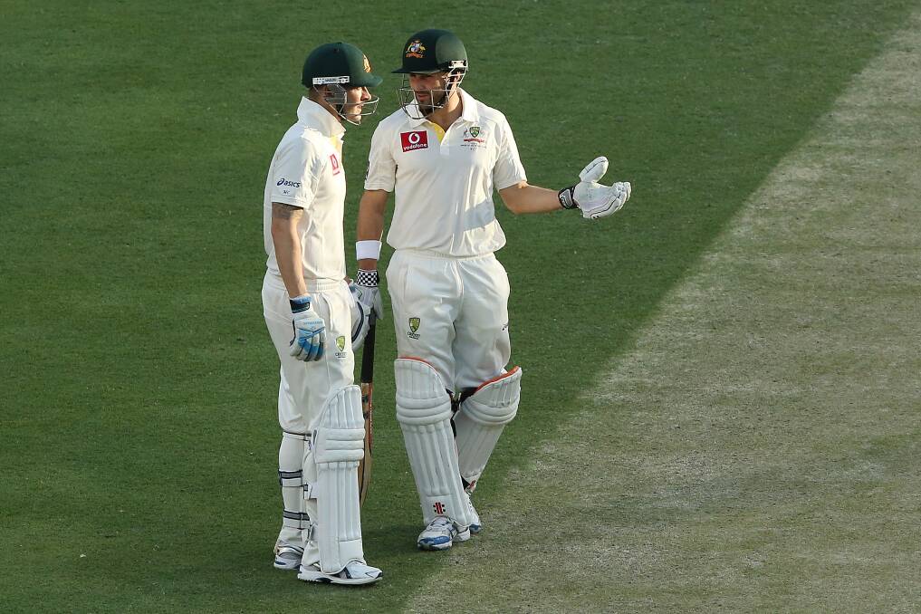 Michael Clarke and Ed Cowan of Australia talk during day three of the First Test match between Australia and South Africa at The Gabba in Brisbane, Australia. Photo by Chris Hyde/Getty Images