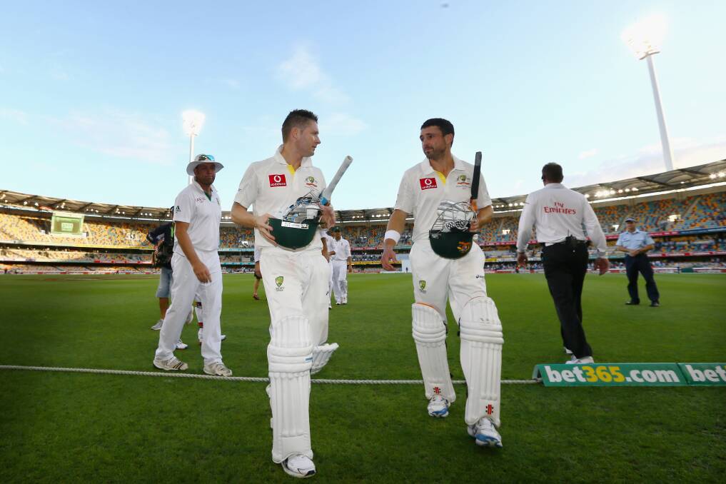 Michael Clarke and Ed Cowen of Australia leave the field at the end of play on day three of the First Test match between Australia and South Africa at The Gabba in Brisbane, Australia. Photo by Mark Kolbe/Getty Images