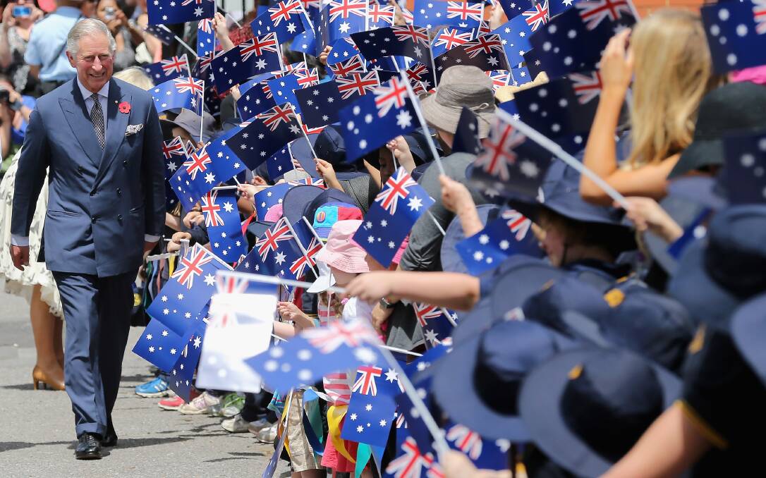 Schoolchildren wave Australian flags as Prince Charles, Prince of Wales visits Kilkenny Primary School on November 7, 2012 in Adelaide, Australia. Photo by Chris Jackson/Getty Images