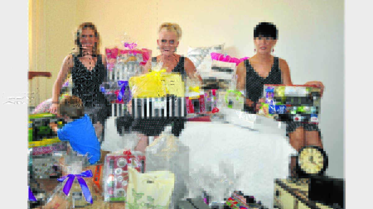 Nicole Rosser, Jacinta Rawson and Nicole Ross amongst some of the fabulous prizes up for grabs at the TransTank Miss Priscilla Dinner.  Photo:  Barbara Reeves
