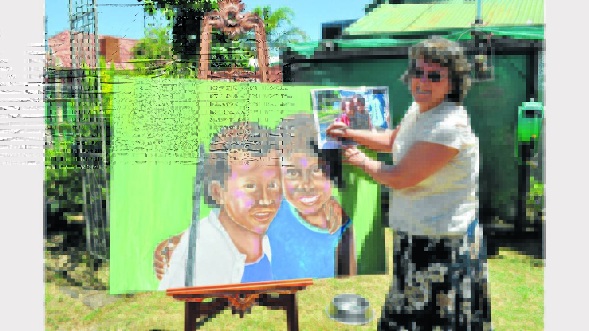Local artist, Bev Rowe works on her special painting for the Elvis Gospel Service this Sunday.