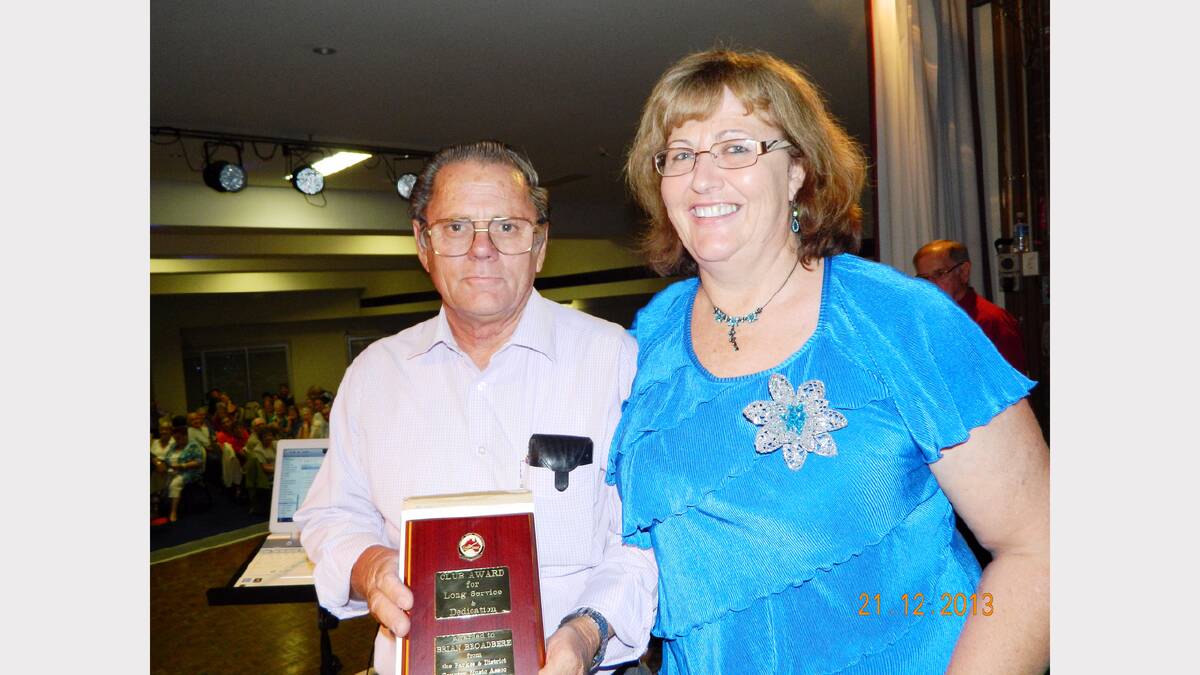 Parkes Country Music Association president, Lindy Charlton presents Brian (Tich) Broadbere with a special award at the charity muster.   Five members of the assocation were honoured.                    