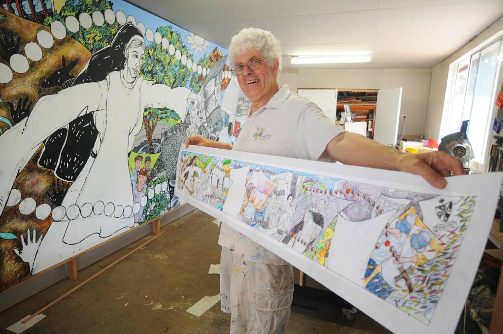 Artist Michael Winters with the first section of a 15-metre mural for Rosary Primary School at Watson, ACT. Photo AMY McINTYRE