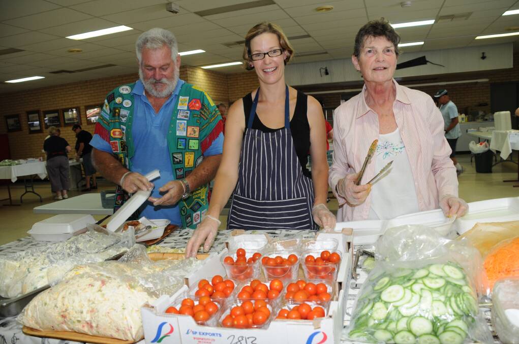 Dubbo Show Society volunteers Ray Hawkins, Kristen Strahorn and Kay Primmer busily preparing meals for the Victorian Scouts. 									 Photo: LISA MINNER
